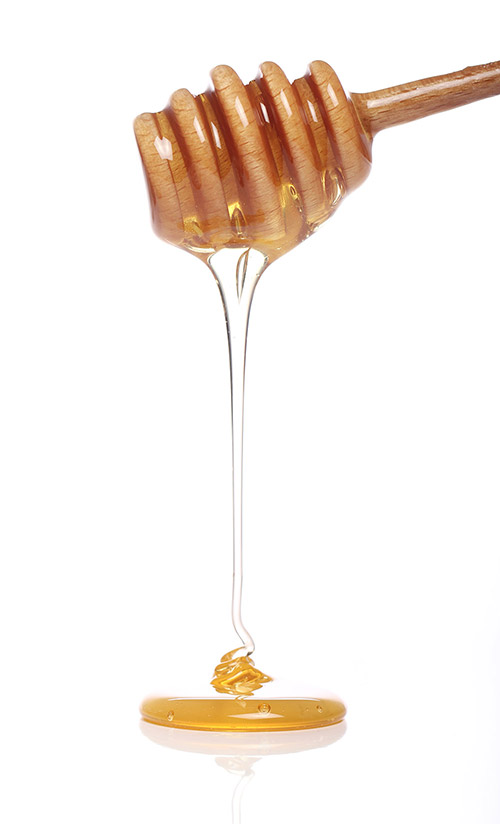 honey-dripping-from-wooden-spoon honey-dripping-from-wooden-spoon